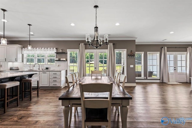 dining area featuring recessed lighting, a notable chandelier, dark wood-style floors, and french doors