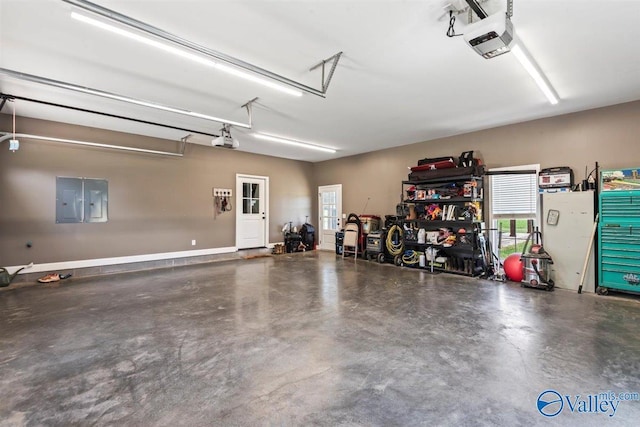 garage with a garage door opener and electric panel