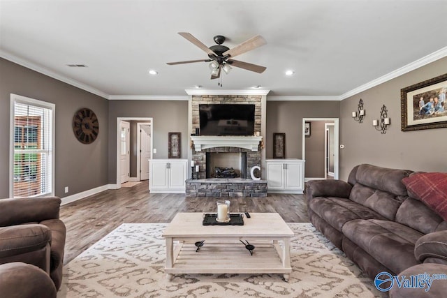 living room with visible vents, ornamental molding, wood finished floors, baseboards, and a ceiling fan