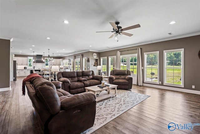 living area with crown molding, recessed lighting, ceiling fan, and visible vents