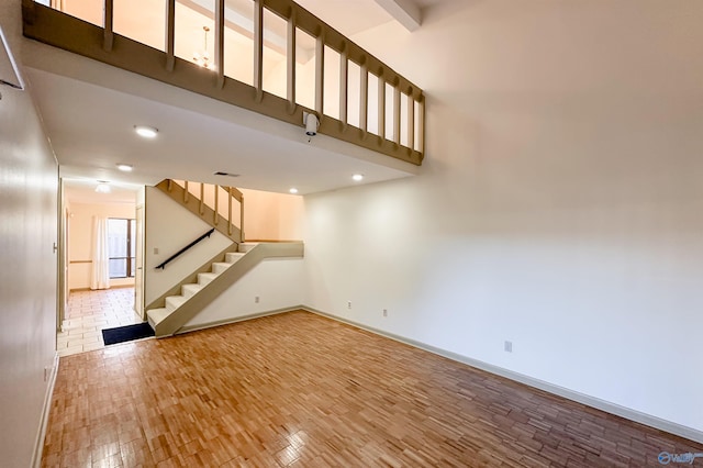 unfurnished living room featuring beamed ceiling