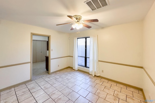 spare room featuring light tile patterned floors and ceiling fan