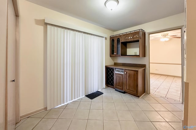 kitchen with light tile patterned floors and ceiling fan