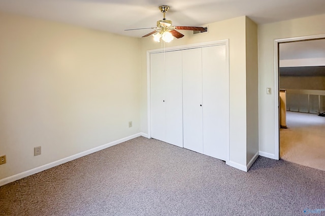 unfurnished bedroom with ceiling fan, carpet flooring, and a closet