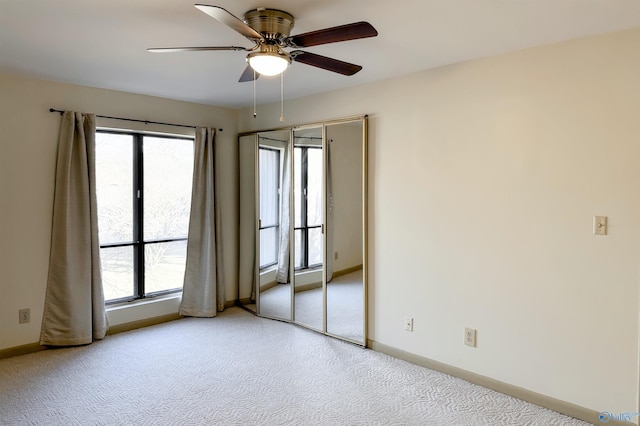 carpeted empty room featuring ceiling fan