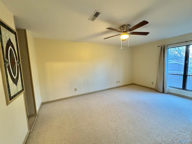 carpeted empty room featuring ceiling fan