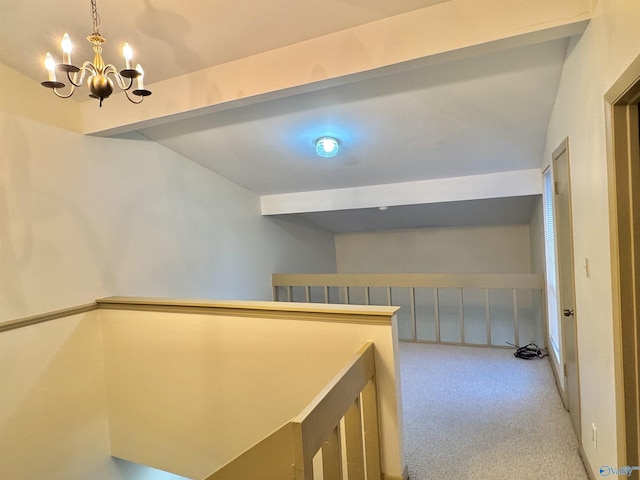 hallway with an inviting chandelier, beamed ceiling, and carpet flooring