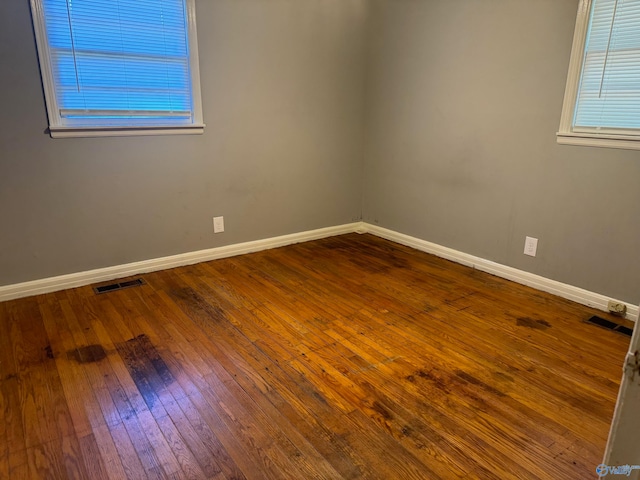 empty room with hardwood / wood-style flooring