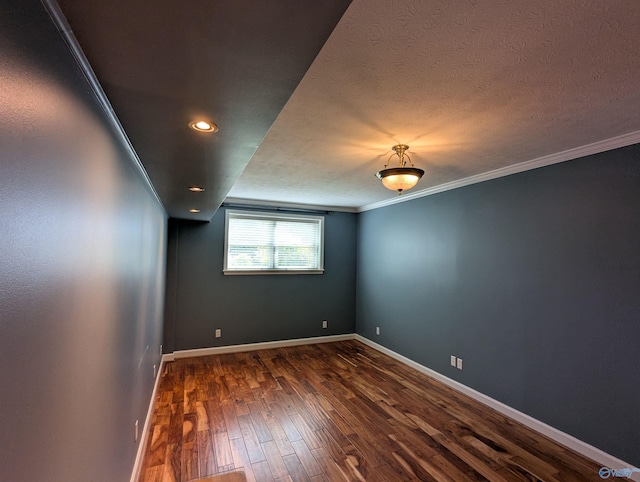 unfurnished room featuring crown molding, baseboards, a textured ceiling, and dark wood-style flooring
