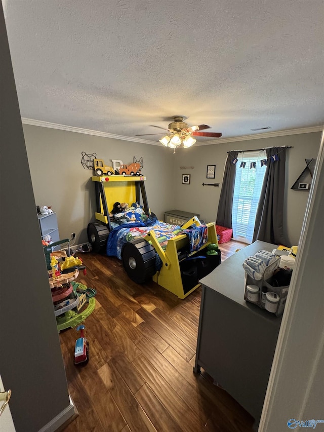 bedroom with wood finished floors, a textured ceiling, ceiling fan, and crown molding