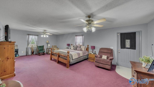 carpeted bedroom with multiple windows, a textured ceiling, and ceiling fan