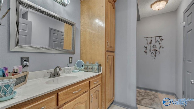 bathroom featuring vanity and a textured ceiling