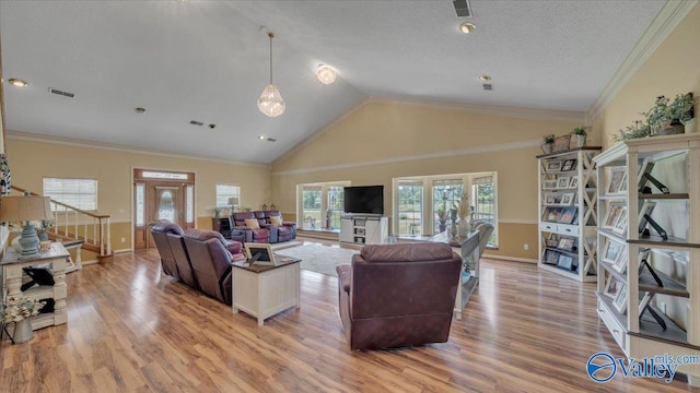 living area featuring wood finished floors, visible vents, and ornamental molding