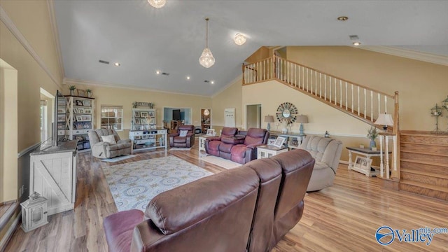 living room with visible vents, high vaulted ceiling, wood finished floors, stairway, and crown molding