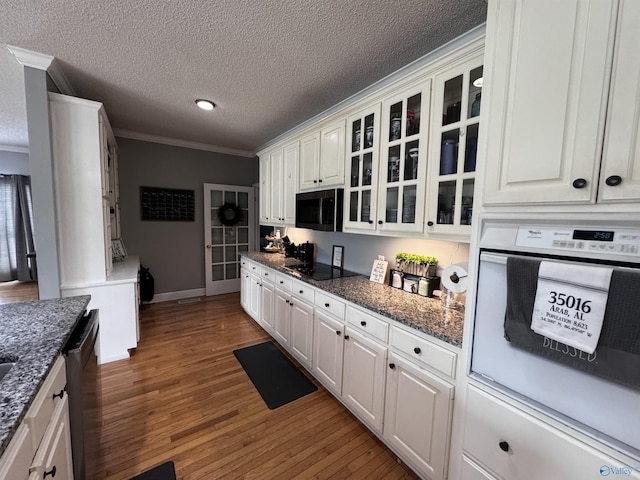 2032 Red Oak Ln NE, Arab, AL 35016 - kitchen with white oven, ornamental molding, glass insert cabinets, white cabinets, and wood finished floors