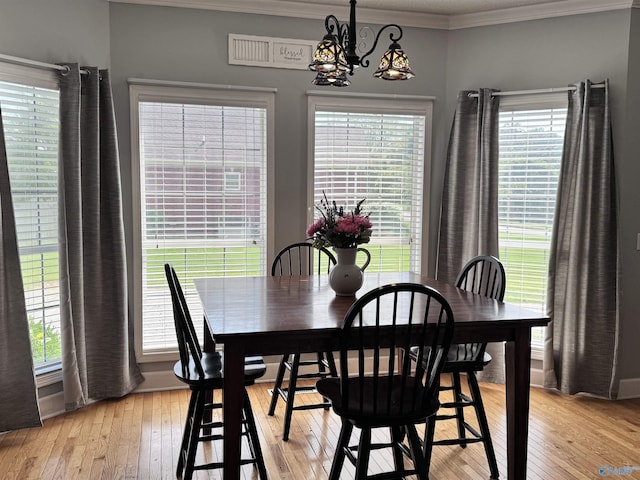 2032 Red Oak Ln NE, Arab, AL 35016 - dining space with crown molding, a chandelier, light wood-style flooring, and plenty of natural light