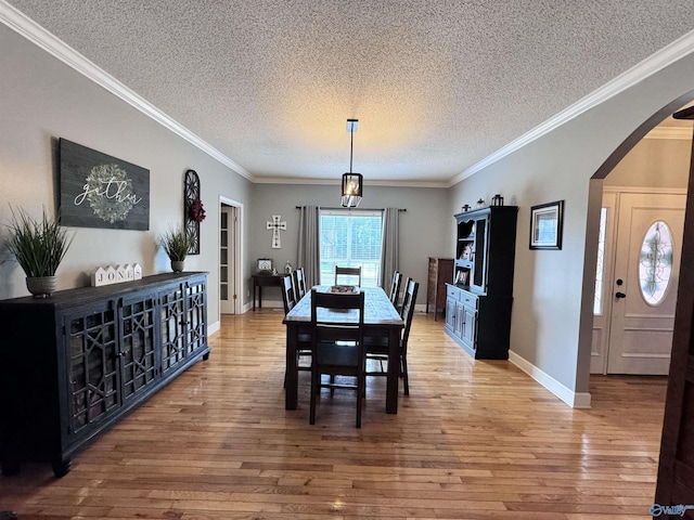 2032 Red Oak Ln NE, Arab, AL 35016 - dining area with a textured ceiling, arched walkways, light wood-type flooring, and ornamental molding