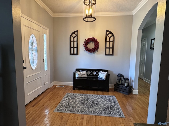 2032 Red Oak Ln NE, Arab, AL 35016 - entryway featuring wood-type flooring, arched walkways, ornamental molding, and a textured ceiling