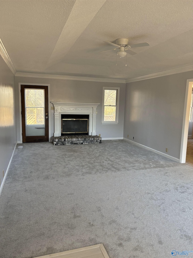 unfurnished living room with light carpet, ceiling fan, ornamental molding, and a textured ceiling