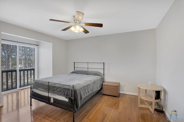 bedroom with wood finished floors, a ceiling fan, and baseboards