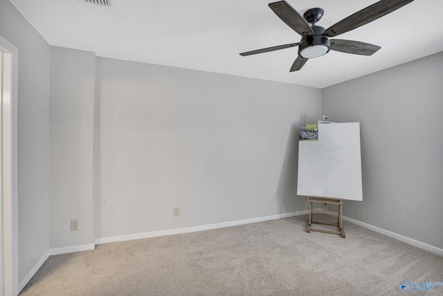 empty room featuring baseboards, a ceiling fan, and carpet flooring