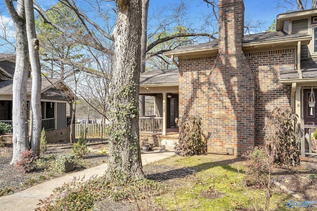 view of front of home with brick siding and fence