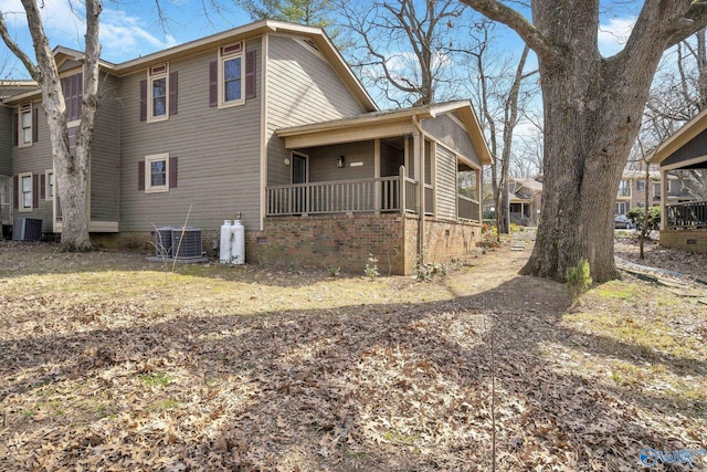 view of home's exterior featuring central air condition unit and covered porch