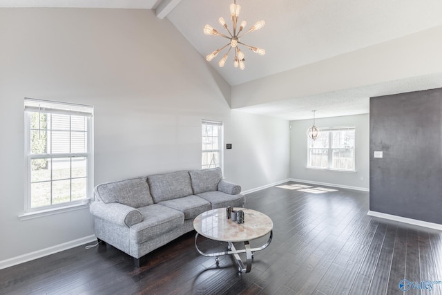 living area featuring dark wood finished floors, a notable chandelier, beamed ceiling, and baseboards