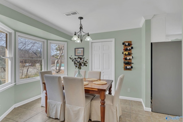 dining space with a chandelier, light tile patterned flooring, visible vents, baseboards, and crown molding