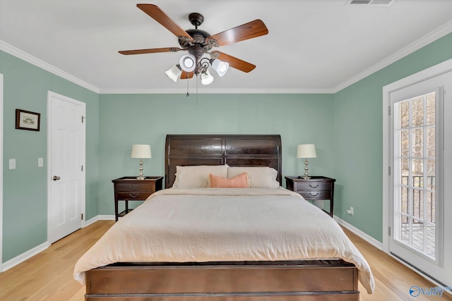 bedroom featuring multiple windows, light wood-type flooring, and crown molding