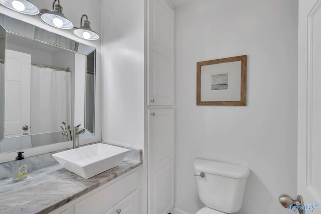 bathroom featuring vanity and toilet