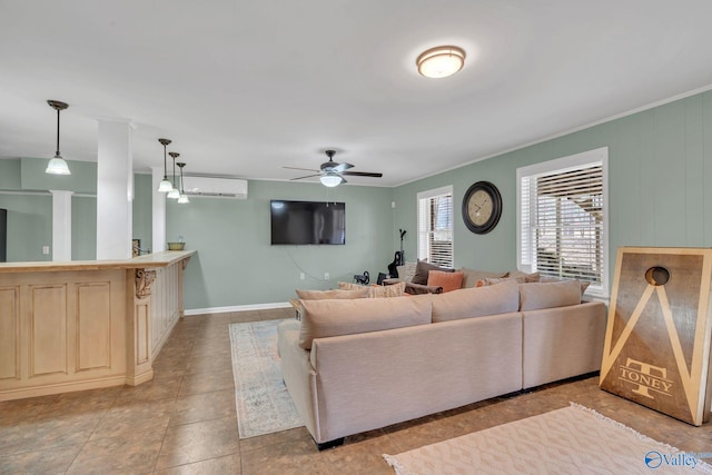 living room featuring light tile patterned floors, baseboards, ceiling fan, a wall mounted air conditioner, and crown molding