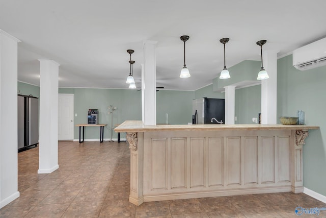 kitchen featuring stainless steel fridge, light countertops, cream cabinetry, and a wall mounted air conditioner