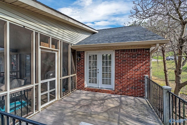 wooden terrace featuring a sunroom and french doors