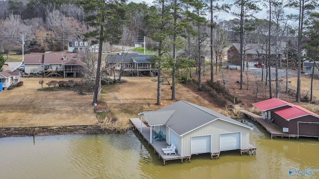 dock area with a water view, boat lift, and a residential view