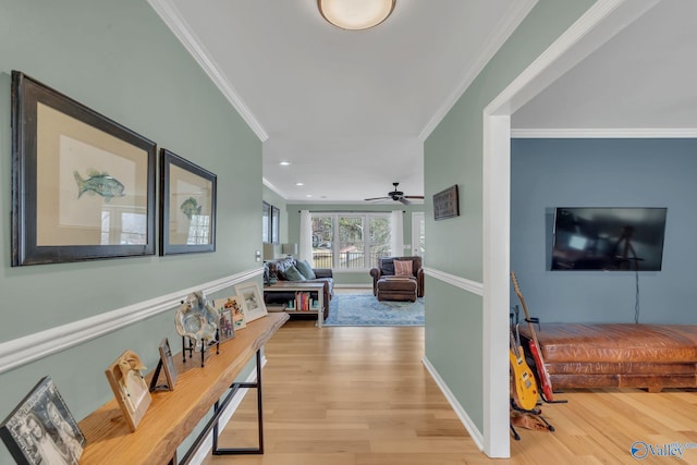 hallway with baseboards, ornamental molding, recessed lighting, and light wood-style floors