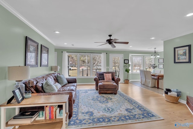 living room featuring ornamental molding, recessed lighting, light wood-style floors, and baseboards