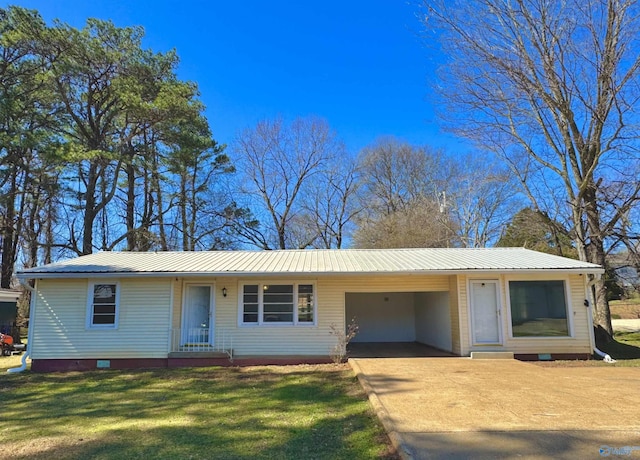 ranch-style home with a carport, concrete driveway, a front yard, and metal roof