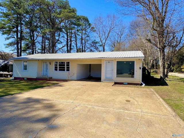 ranch-style house with an attached carport, concrete driveway, a front yard, and metal roof