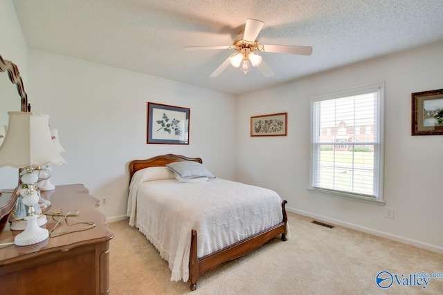24430 Chadwick Dr, Athens, AL 35613 - bedroom featuring light carpet, ceiling fan, and a textured ceiling