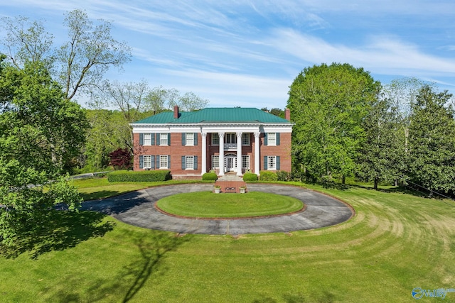 rear view of property with a lawn