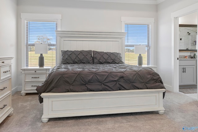 bedroom featuring crown molding, light carpet, and multiple windows