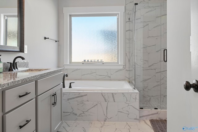 bathroom featuring vanity, a healthy amount of sunlight, and independent shower and bath