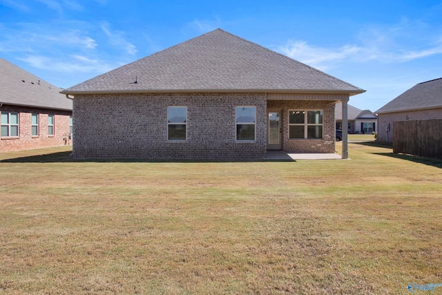 back of property featuring a patio and a lawn