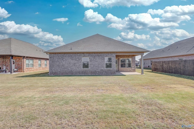 back of house featuring a yard and a patio area