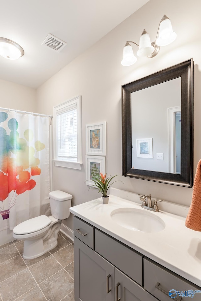 202 Maureen Dr, Madison, AL 35756 - bathroom with vanity, toilet, tile patterned flooring, and baseboards