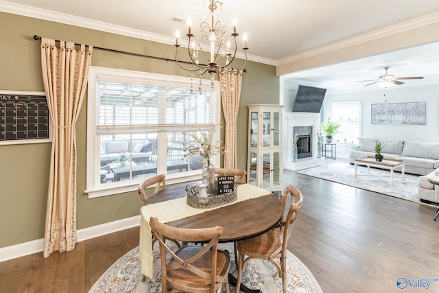 202 Maureen Dr, Madison, AL 35756 - dining room featuring a chandelier, a fireplace, dark wood-style floors, baseboards, and crown molding