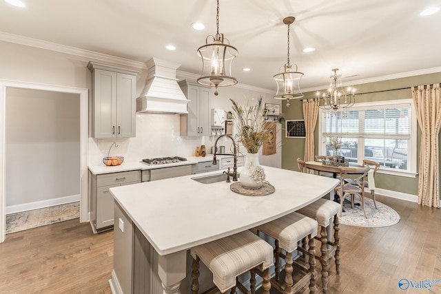 202 Maureen Dr, Madison, AL 35756 - kitchen featuring a sink, gray cabinets, a chandelier, stainless steel gas stovetop, and a kitchen island with sink