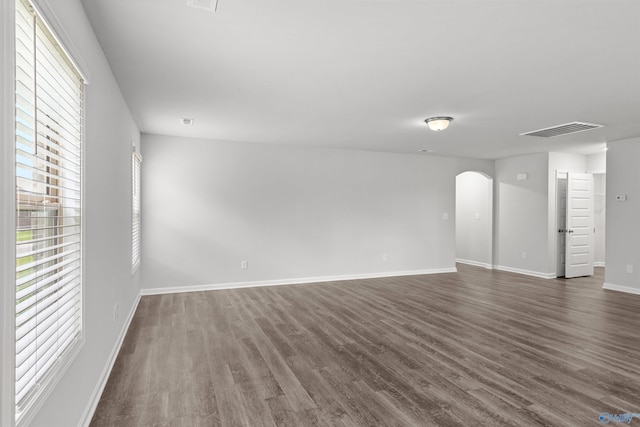 103 Gander Cir, Owens Cross Roads, AL 35763 - empty room with arched walkways and dark wood-type flooring