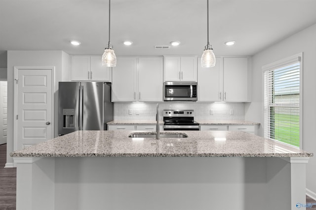 103 Gander Cir, Owens Cross Roads, AL 35763 - kitchen with stainless steel appliances, a center island with sink, white cabinets, decorative backsplash, and dark wood finished floors